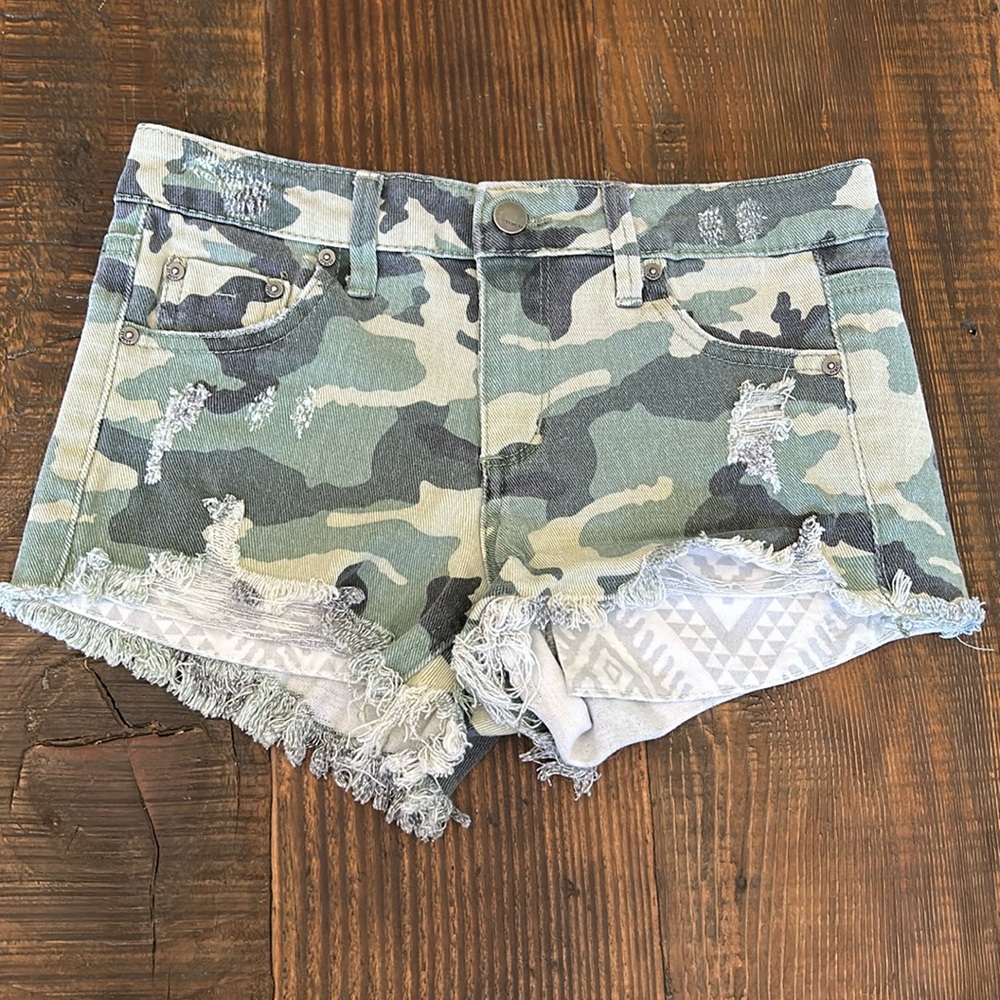 Camouflage distressed jeans shorts.  Girls size 10